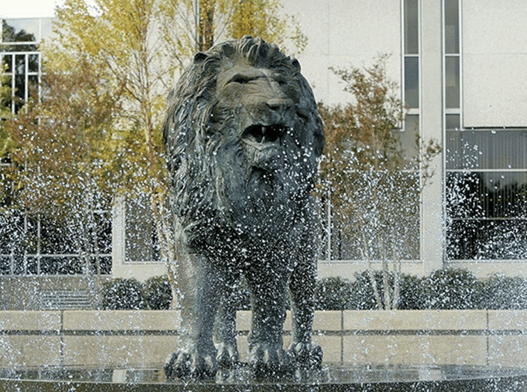 Old Dominion University lion fountain surrounded by water and trees